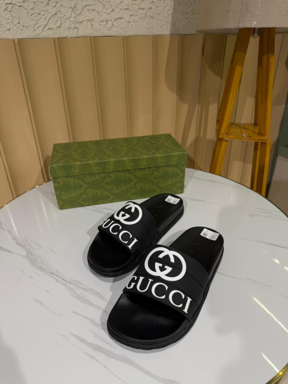 Gucci black slides, specifically featuring the iconic Interlocking G logo.
