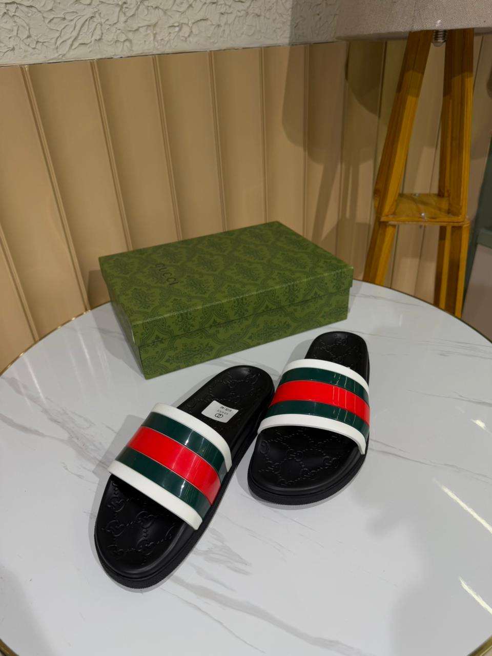 Gucci black rubber slide sandals featuring red and green bands