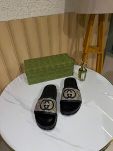 Gucci slides featuring the brand’s iconic GG monogram canvas.