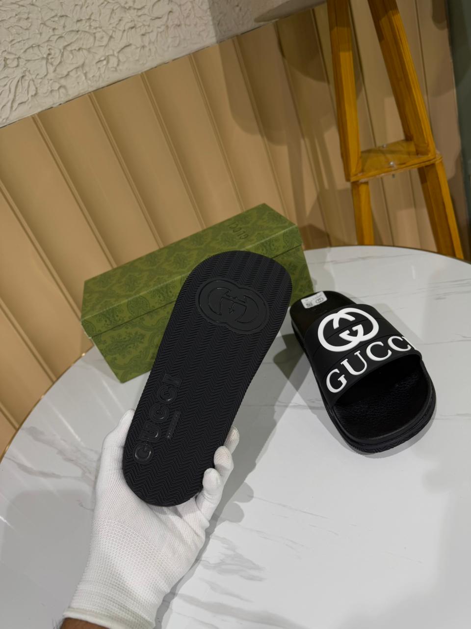 Gucci black slides, specifically featuring the iconic Interlocking G logo. - Image 4